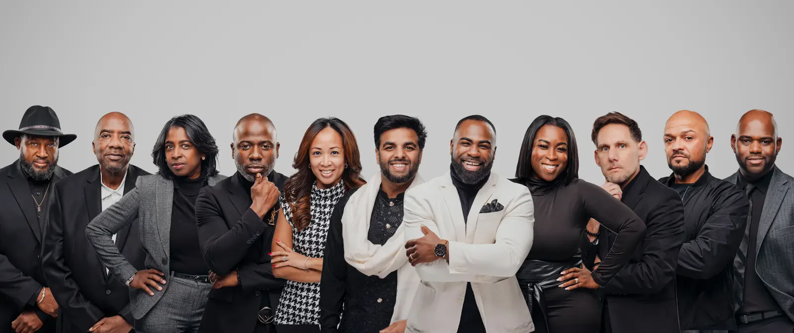 A full team photographed together on a studio background